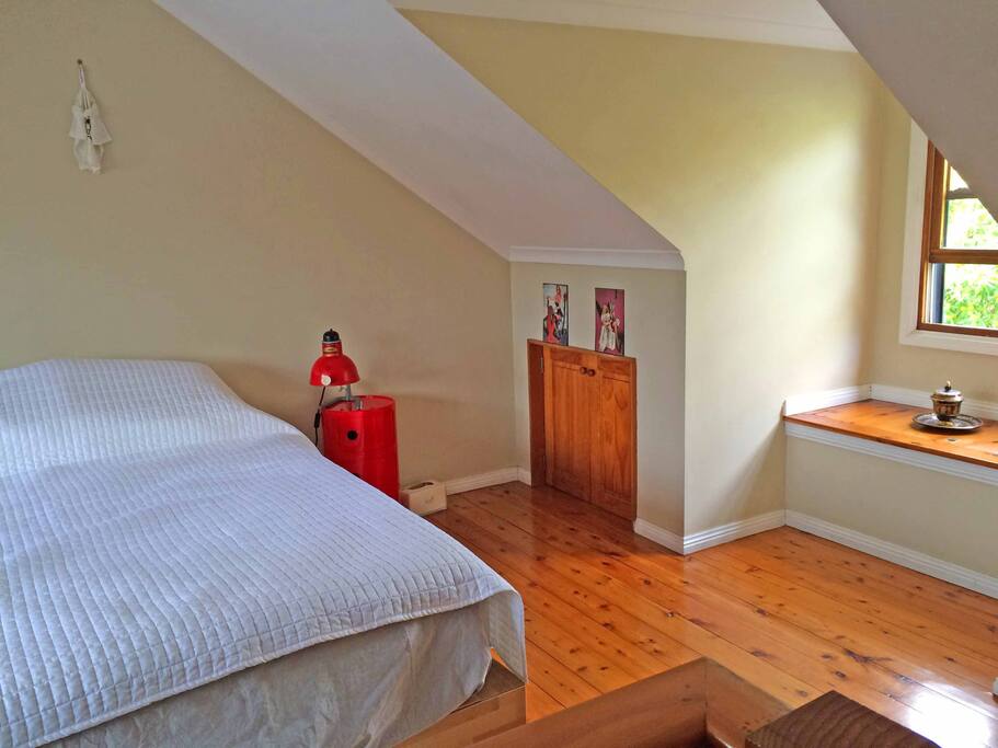 Master bedroom opens out onto its own balcony with afternoon sun.