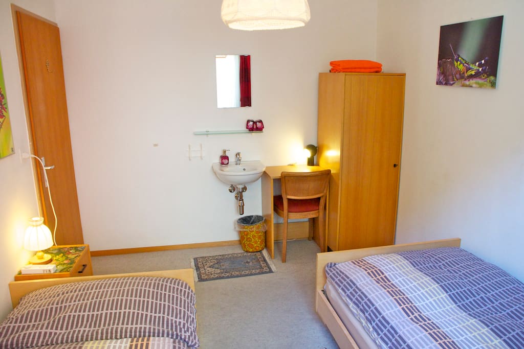 2 single bed room with wash basin.