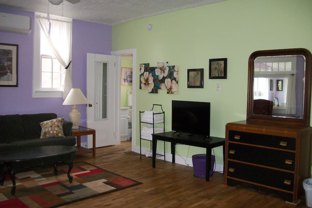 Living area with door leading into the bathroom.