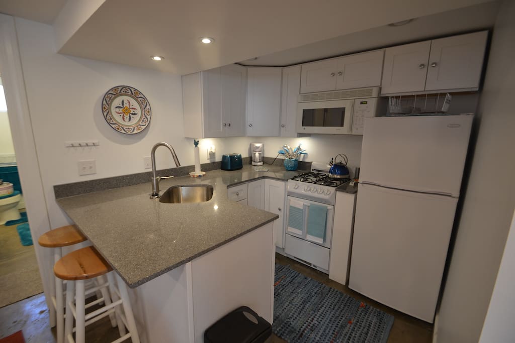 Kitchen comes fully equipped with dishes, small oven/range and microwave. Counter bar. No dishwasher.