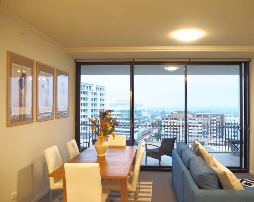 Separated by alfresco sliding doors, the living room flows invitingly through to the balcony.