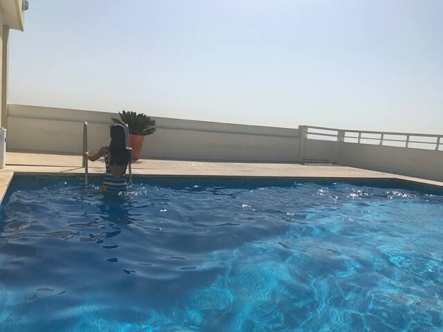 Large studio in a building with swimming pool.