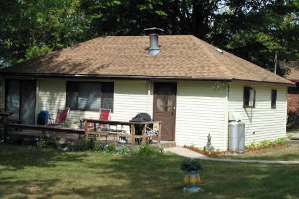 The cottage with the kithen door and the deck.