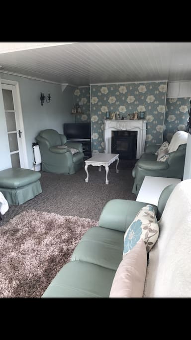 Private cosy living room with stove.