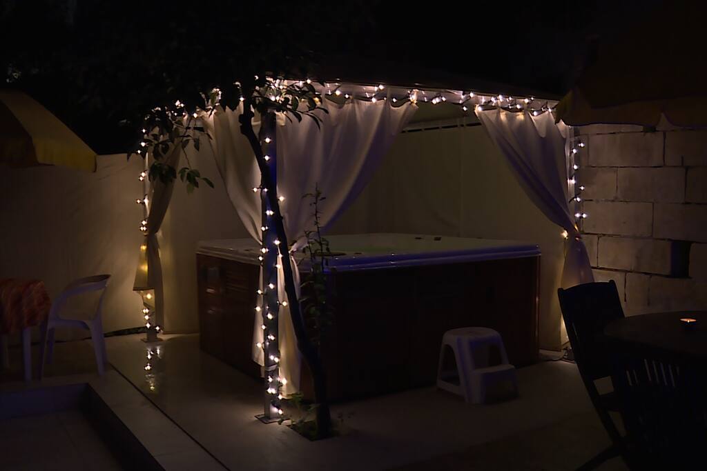gazebo and jacuzzi spa as this appears at night