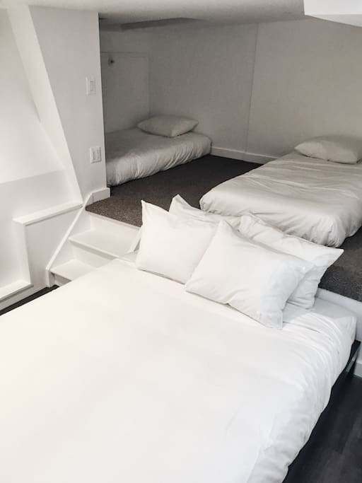 "Loft" area with two twins and queen-sized bed.