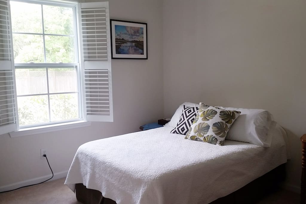 Queen sized bed with a north facing window