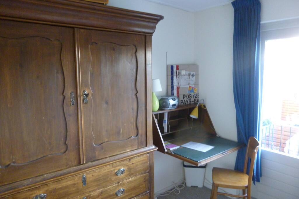 Closer and small desk for laptop or writing.