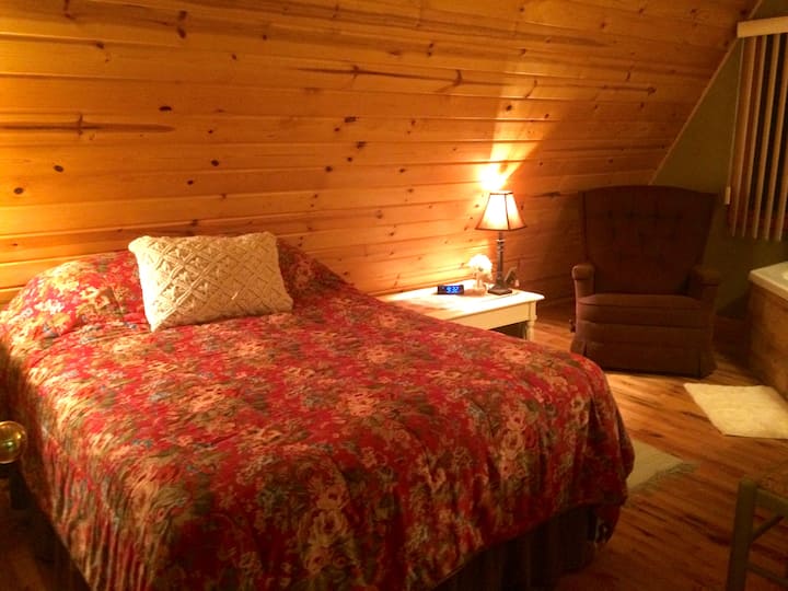 The downstairs double bed at night, including a comfy reclining chair!
