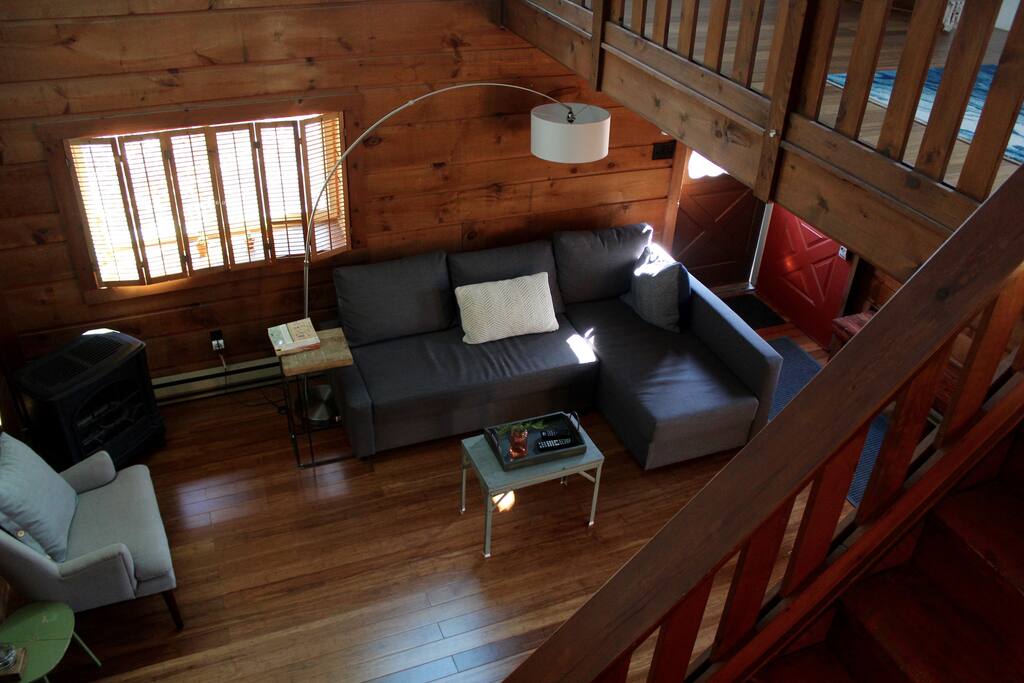 living room complete with TV, pull-out couch, and fireplace