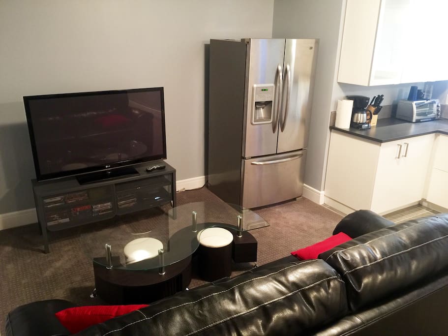 55" Toshiba TV and spacious double-door fridge.