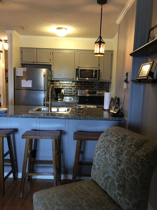 3 bar stools and a high top table