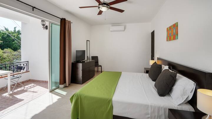 Master bedroom with beautiful balcony, attached bathroom, security box, hair dryer, iron, TV and a VERY comfortable bed!