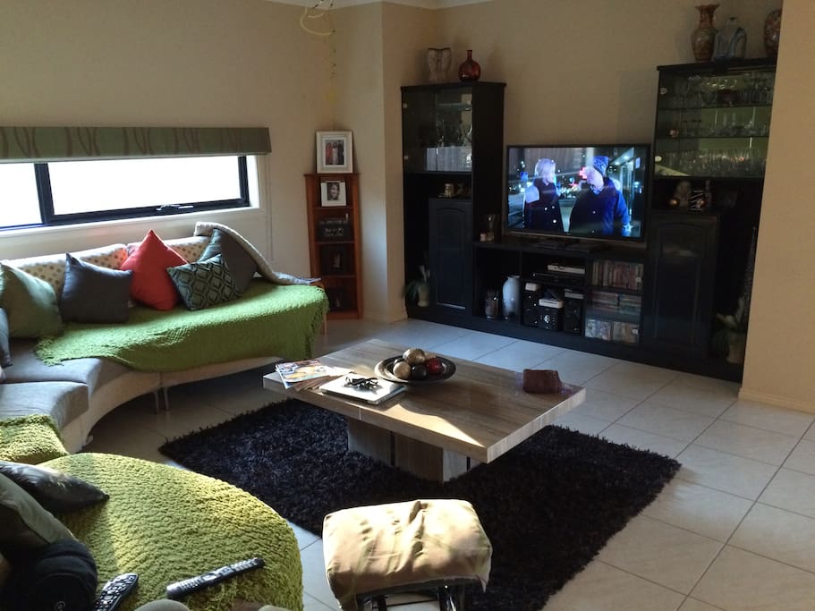 Living room with a huge flat screen TV, Wii, PS4 and DVD player