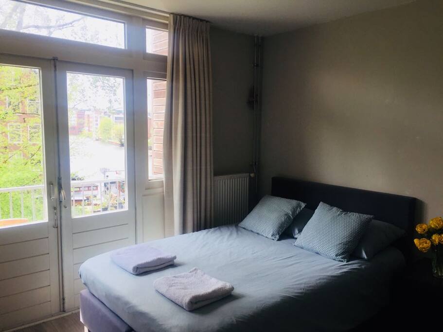 French doors opening onto the south facing balcony with blackout curtains.