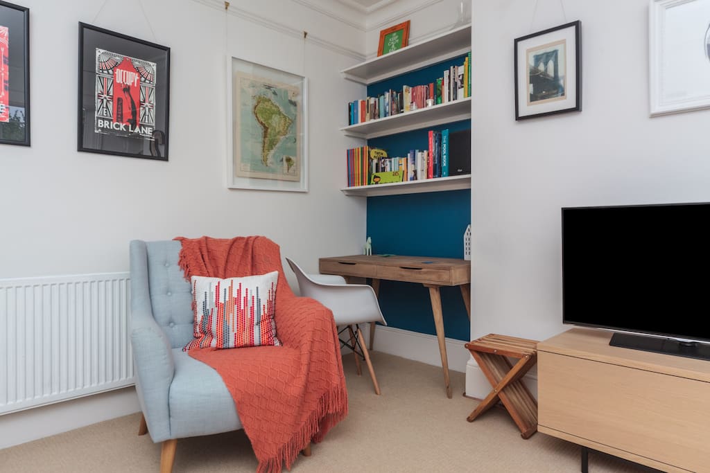 Comfy armchair for reading and laptop-friendly desk.