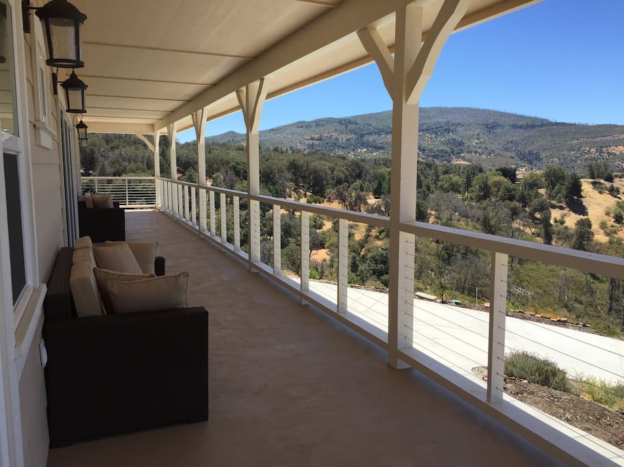 Three 3-seat outdoor sofas are on the wrap-around porch