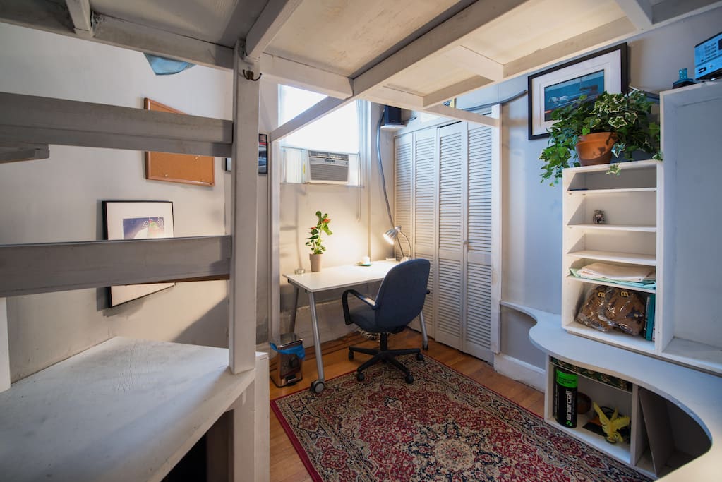 Lower part of the lofted bed featuring a desk, closet, and tons of storage with 6 feet of head room