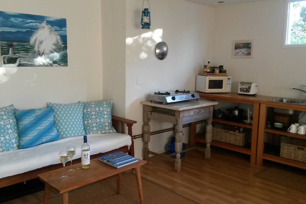 Comfy day bed sitting area with kitchen
