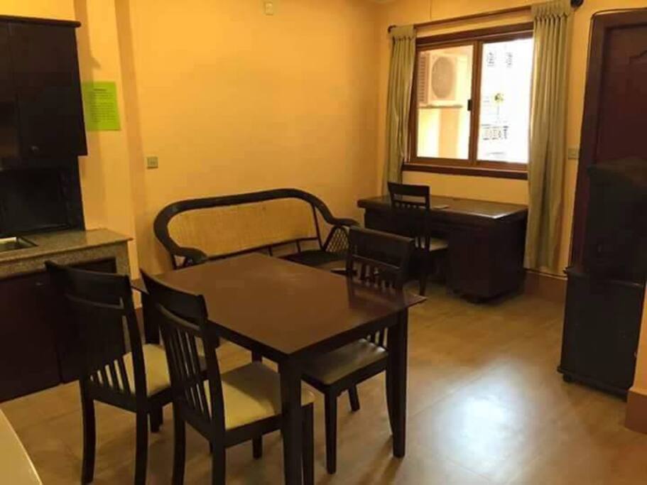 living room has a cable TV, couch, and there's a balcony outside for smoking area for smokers