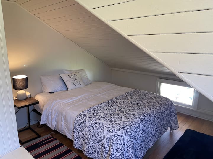 Rear bedroom with queen-size memory foam mattress with adjustable headrest.