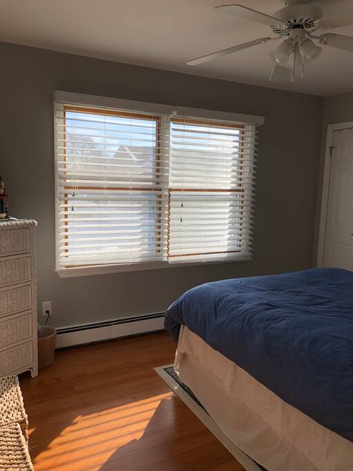 Guest room upstairs with ceiling fan and two closets