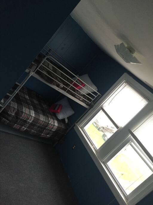 One of the bedrooms, there is a chair and dresser with mirror as well as closet not pictured.