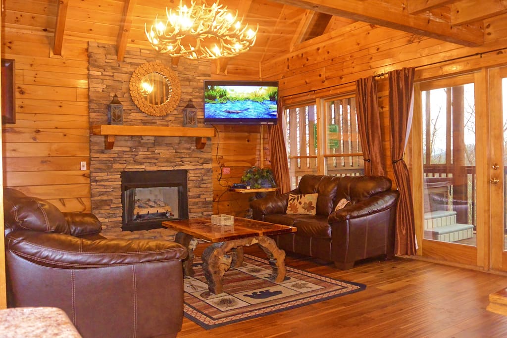 Spacious living room with queen sleeper sofa, stack-stone gas fireplace, 50" LED TV, and DVD Player