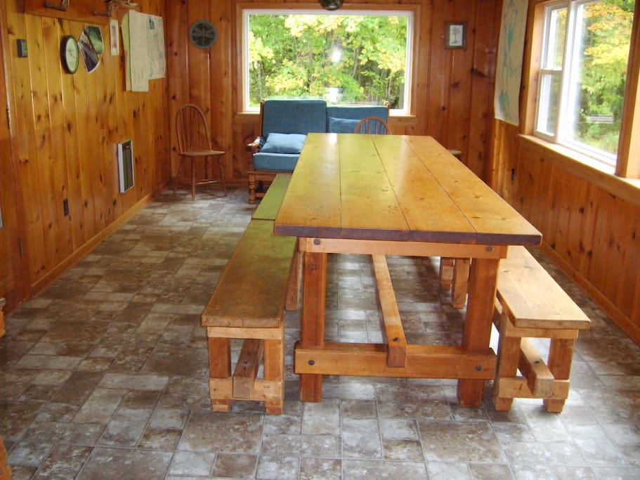 Dining room with one of a kind table with benches. Seats up to 12 people.