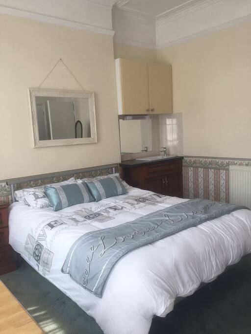 Bedroom with sink area beside it