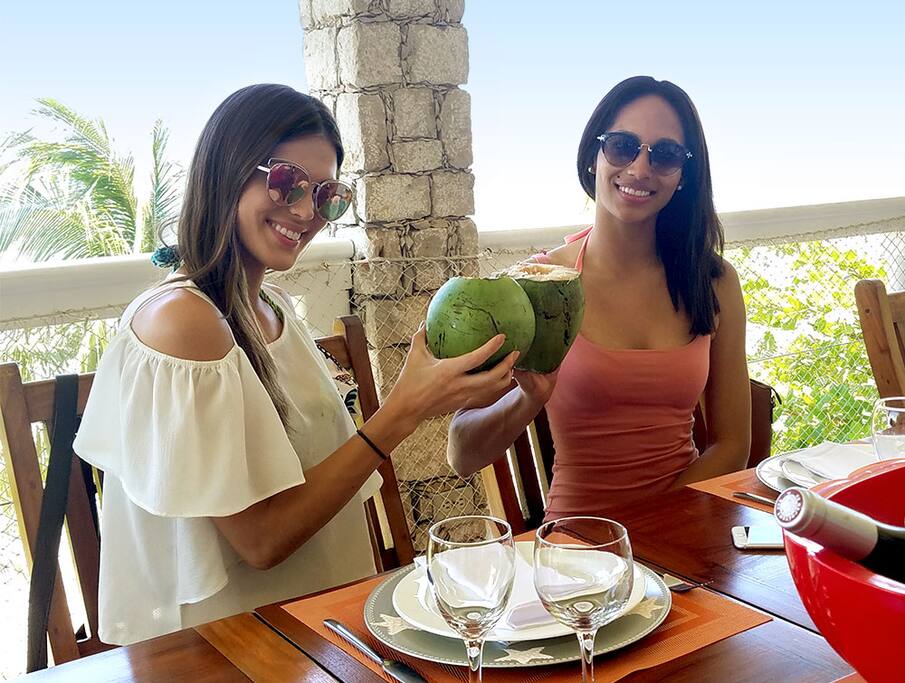 Miss France and Miss Haiti enjoying a coconut!