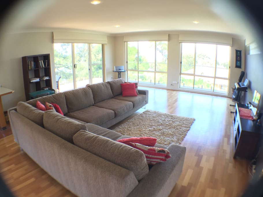 Floor to ceiling windows make for a light & bright living room with views to the ocean and city.