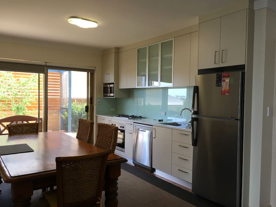 Kitchen/Dining opens to private "courtyard"; protected from winter rain but allows northerly sun.