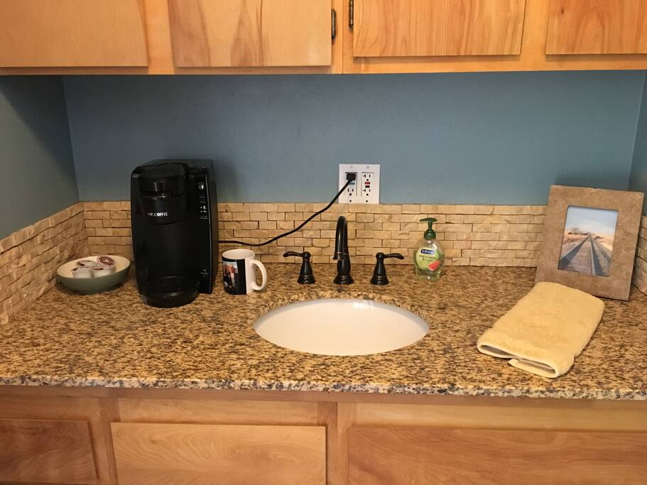 A Keurig in the room with some coffee & tea.