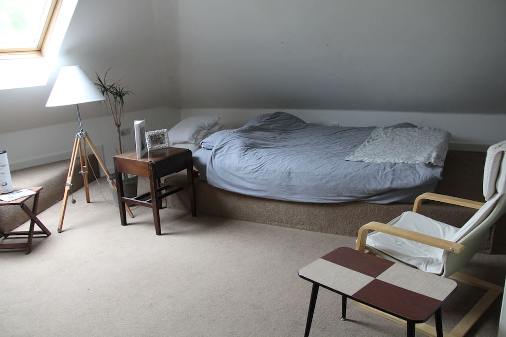 The spacious bedroom including the bed itself.