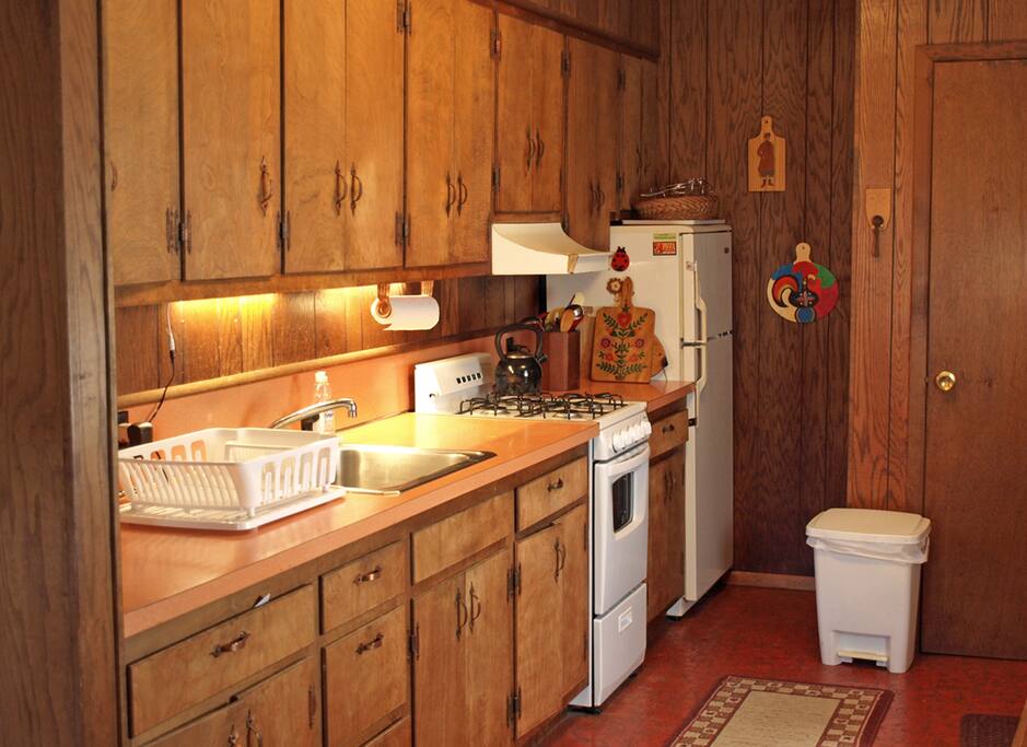 The kitchen's equipped with a gas stove, toaster over and microwave.