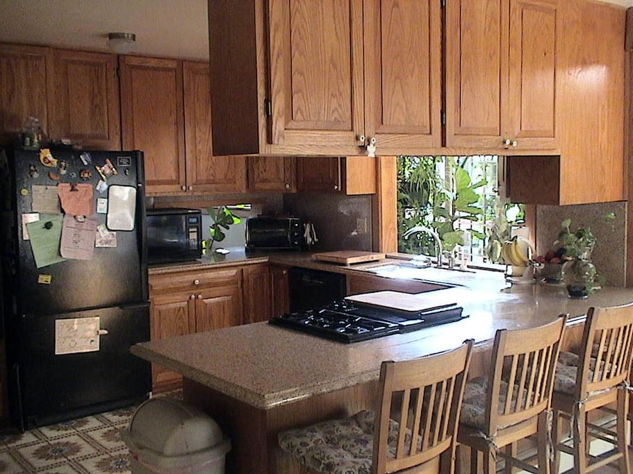 Fully stocked kitchen with Jenn Air range, instant hot water dispenser, pass throughs to dining room and family room.