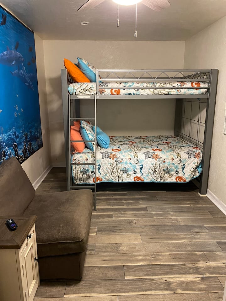 Bedroom with full over full bunk beds and smart TV