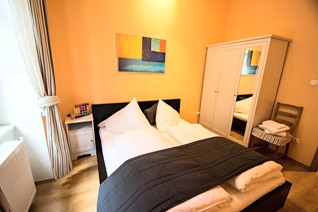 The bedroom with double bed and wardrobe