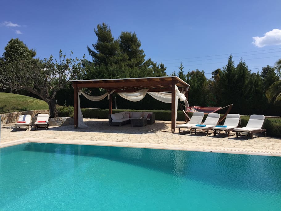 around the pool, pool patio with comfortable patio furniture , swing - hammock and 6 chairs to enjoy the Greek sun.