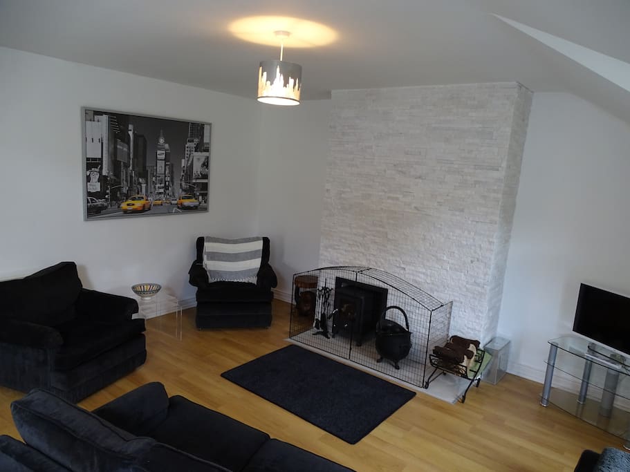 Spacious Seating Area with Peat burning stove and feature Granite Wall