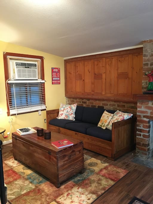 The living room has a window AC/Heat unit.
