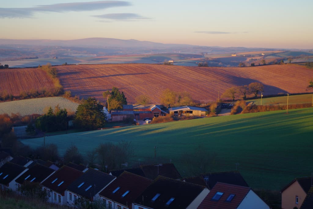 Sun Rising over our barns on a winters morning with Dartmoor in the background
