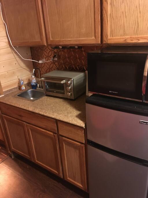 Kitchenette with sink, refrigerator, freezer, microwave and toaster oven