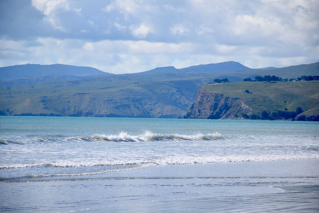 Entrance to Lyttelton Harbour and Sumner Beach. Popular with surfers, kite- surfing directly outside our home, paddle boarding and walking the family dogs.