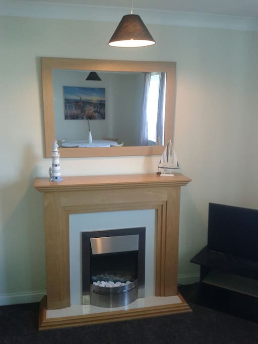 Ornamental fire place with mirror.