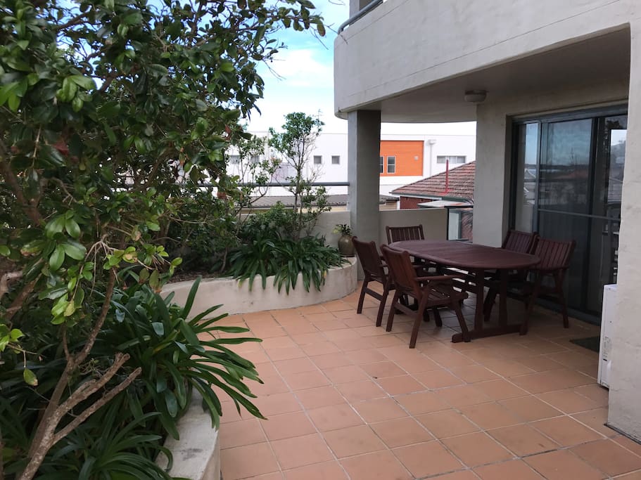 The balcony wraps the apartment living areas and bedrooms, with views of the pool