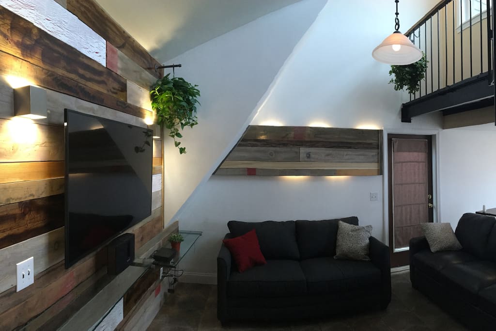 Newly created faux barnboard wall and 60 inch LED TV will please your eyes.