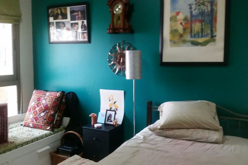 the room for daily rent with one queen bed and one single bed. Facing side is a large wardrobe.