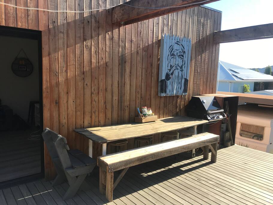 Bbq area and Large table with extra stools underneath.